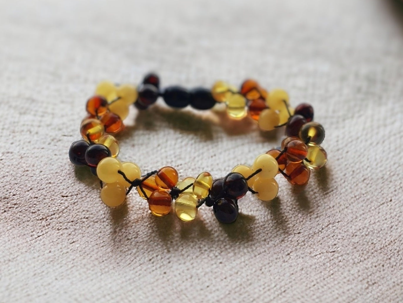 Polished multicolor Baltic amber bracelet with clasp