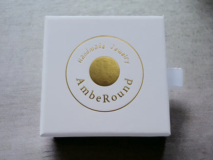 Luxury white gift box with gold amber round brand